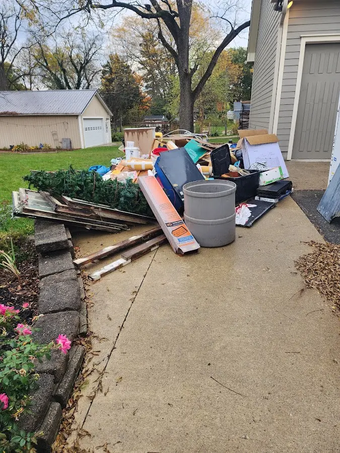 Dumpster being loaded with debris for 3 Yard Dumpster Rental in Upton